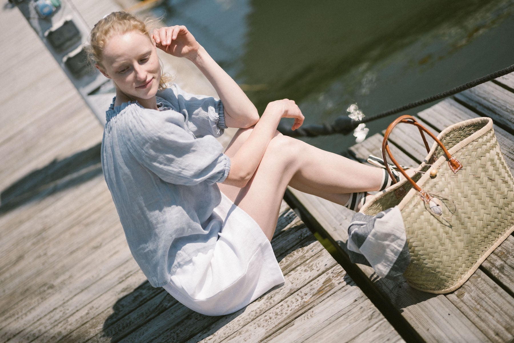 Woman wearing a breathable linen top and shorts on a sunny day.