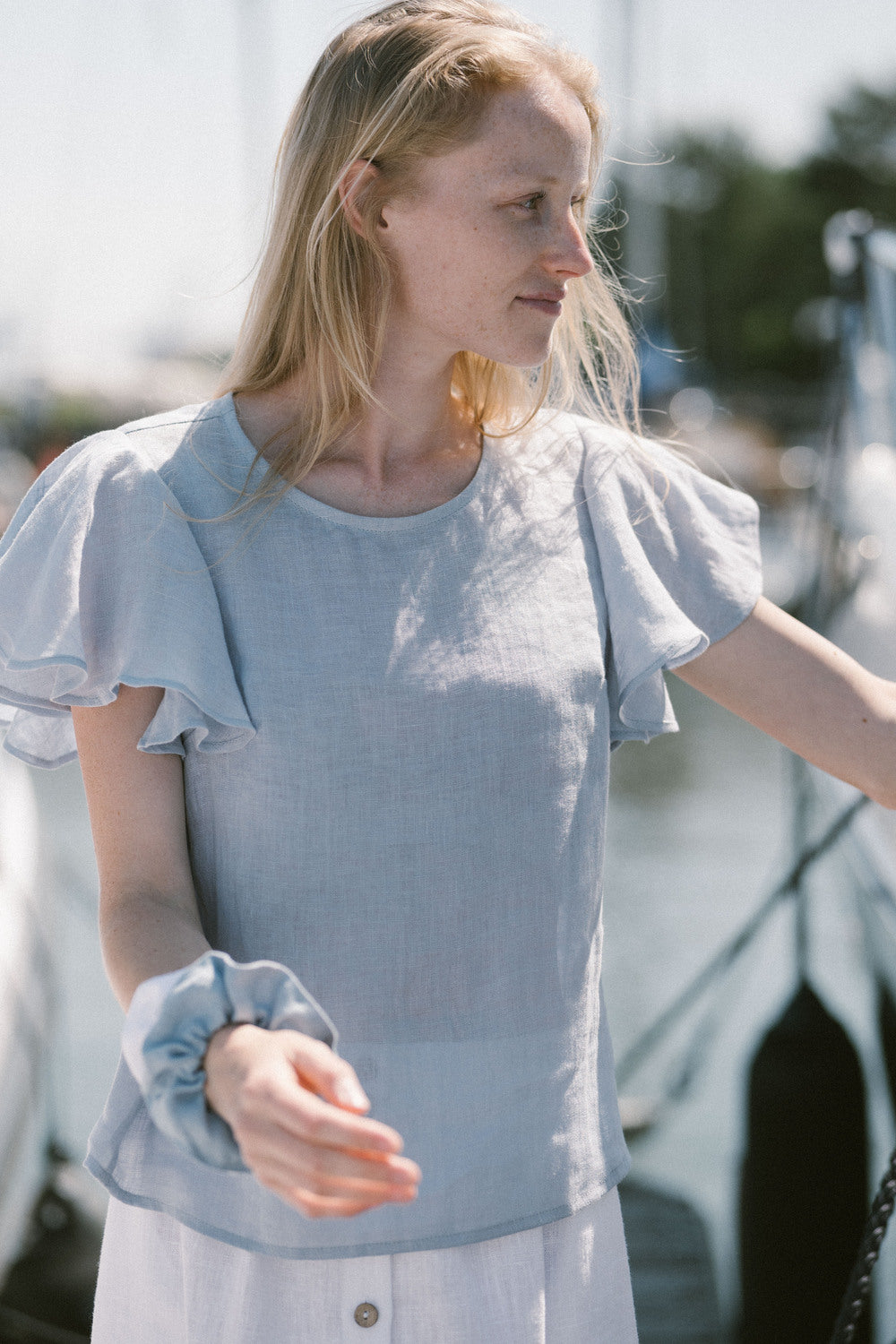 Lightweight gauze linen blouse with flounce sleeves paired with accessories