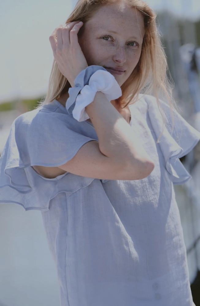 Elegant light blue linen top perfect for warm-weather seaside style