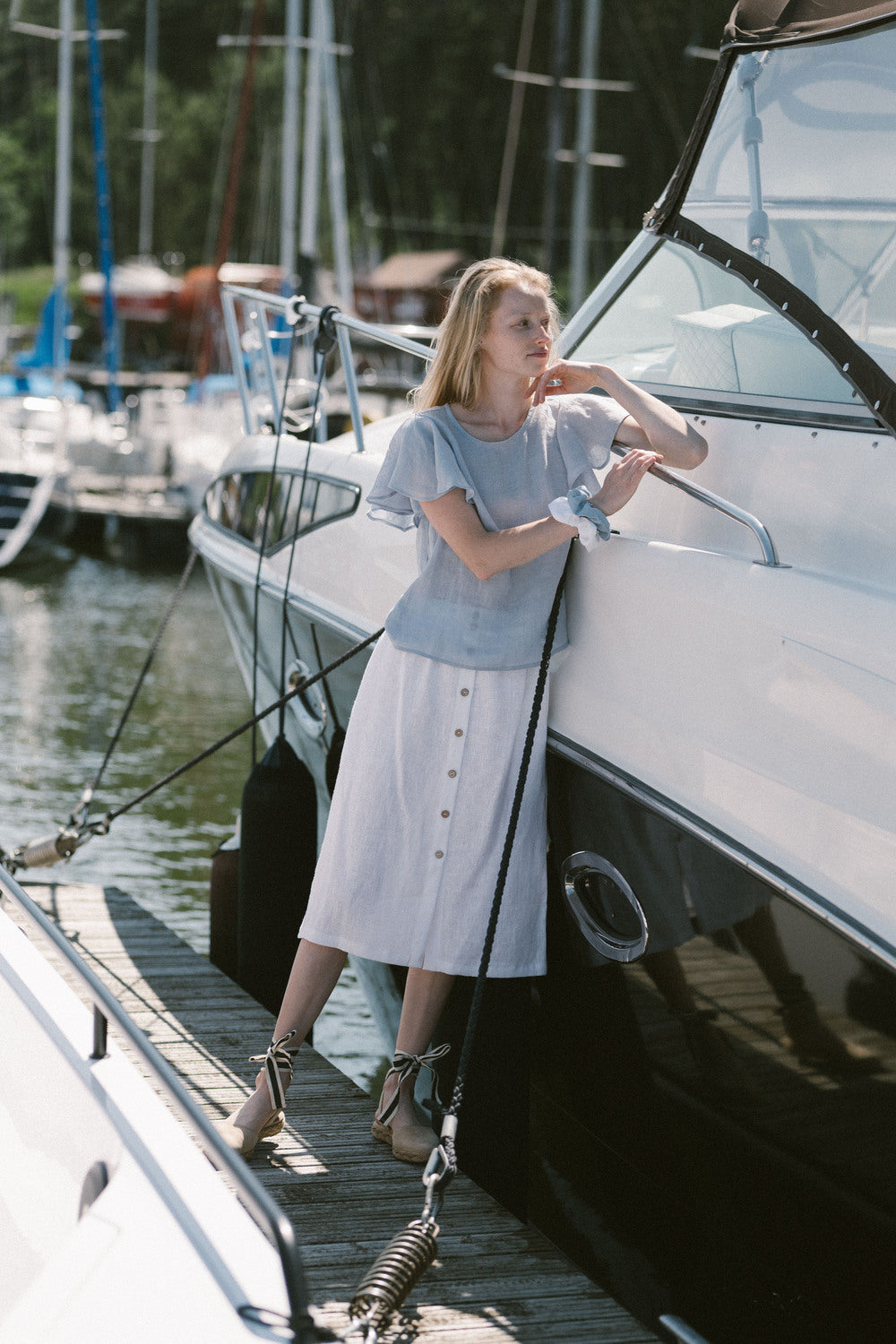 Summer outfit featuring a breezy blue linen top styled with a white button-front skirt