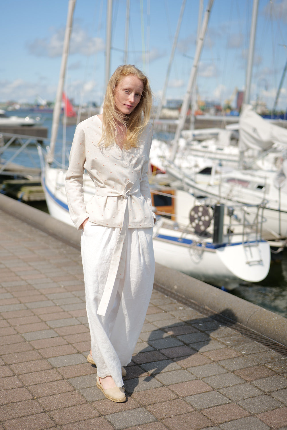 Polka Dot Wrap Blouse Lambada worn together with loose fit trousers in white