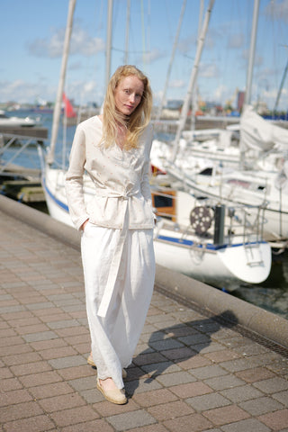 Polka Dot Wrap Blouse Lambada worn together with loose fit trousers in white